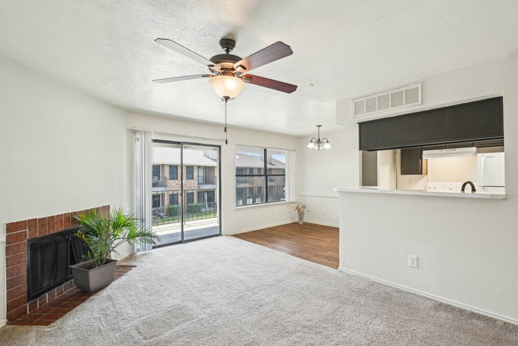 A living room with a fireplace and sliding glass doors.