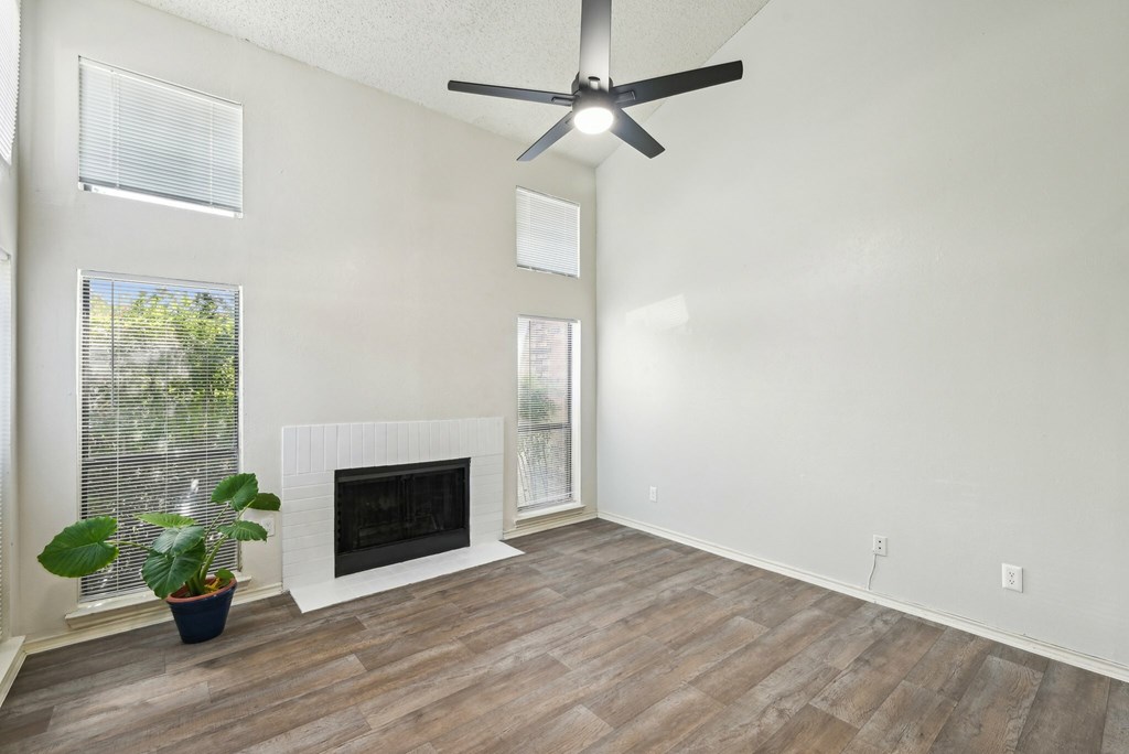 A swimming pool in a residential area surrounded by trees and bushes.