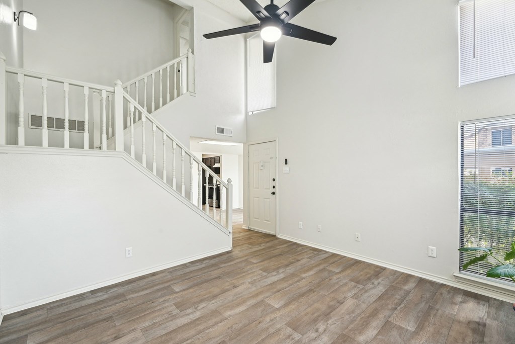 A room with a white door and a mirror on the wall.