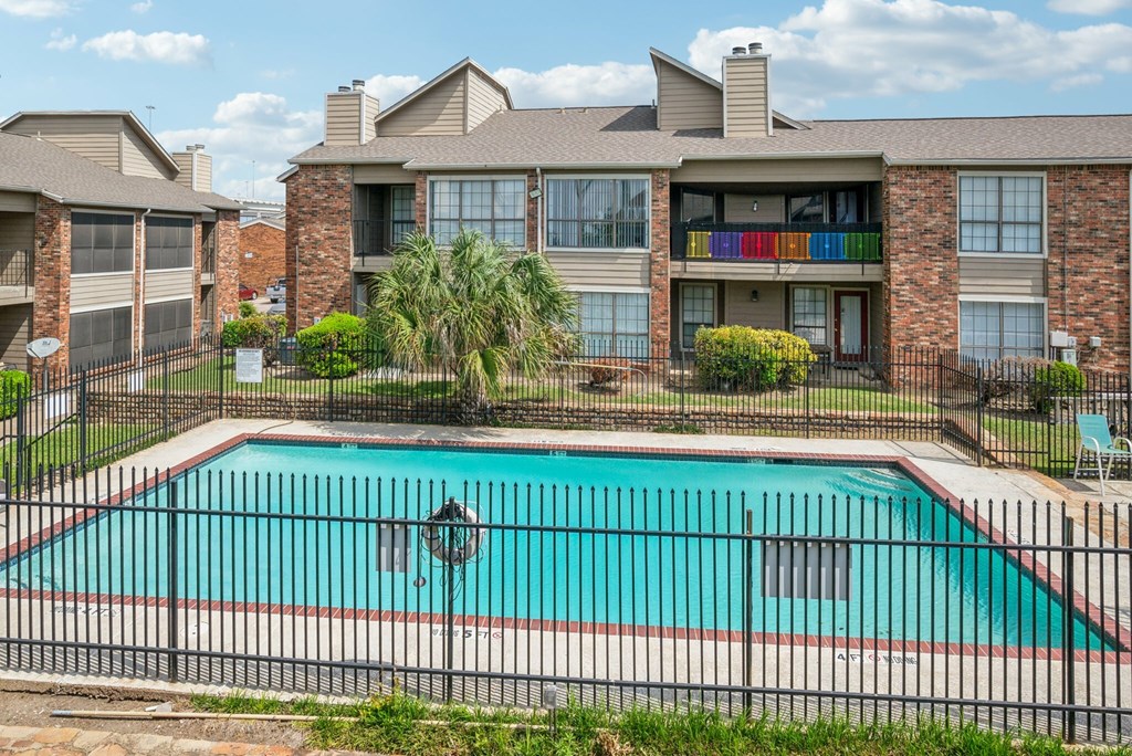 A kitchen with a white stove, white refrigerator, and a sink.