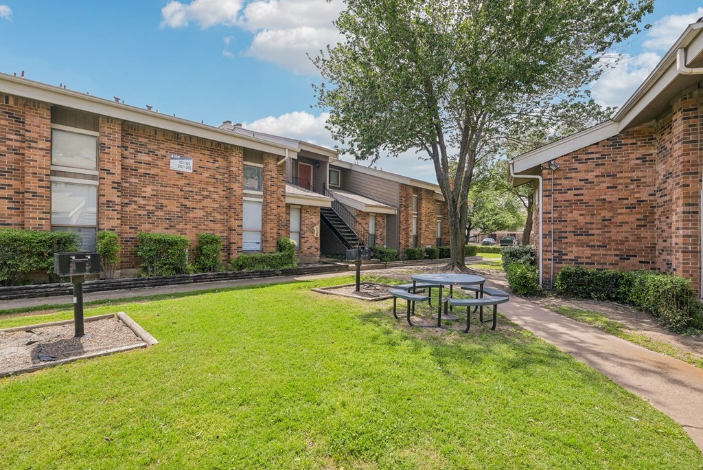 A hallway with a light on the wall and a door at the end.