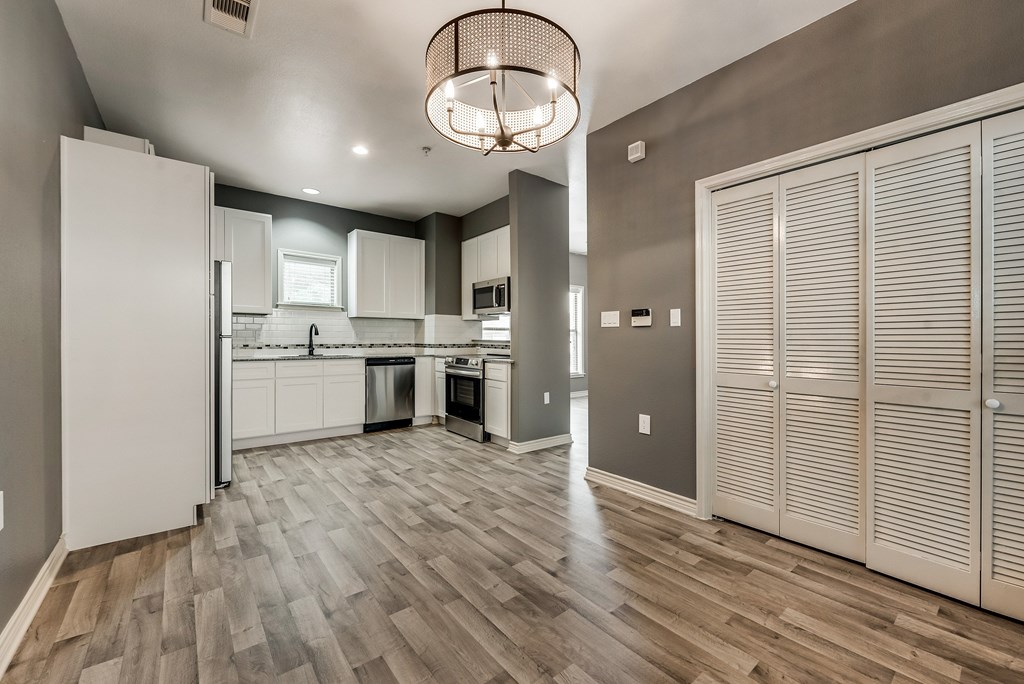 A bathroom with a toilet, sink, and mirror.