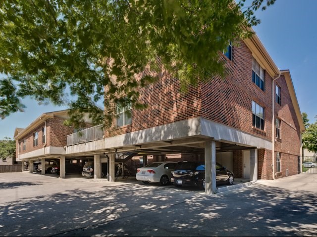 A red brick building with a covered parking garage.