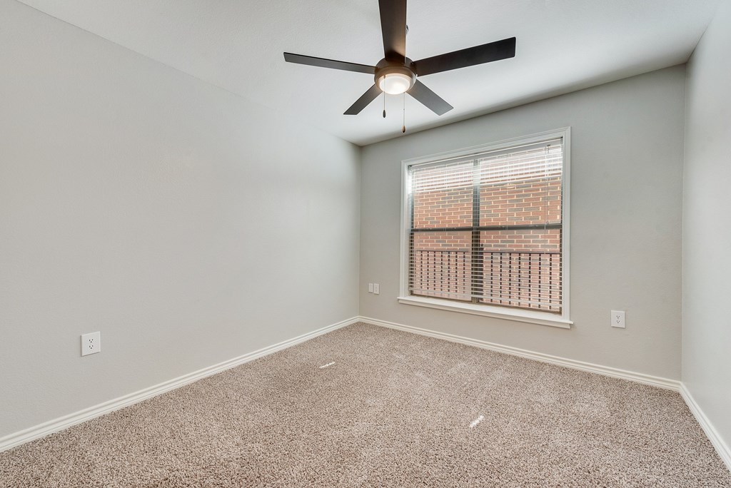 A modern kitchen with white cabinets and stainless steel appliances.