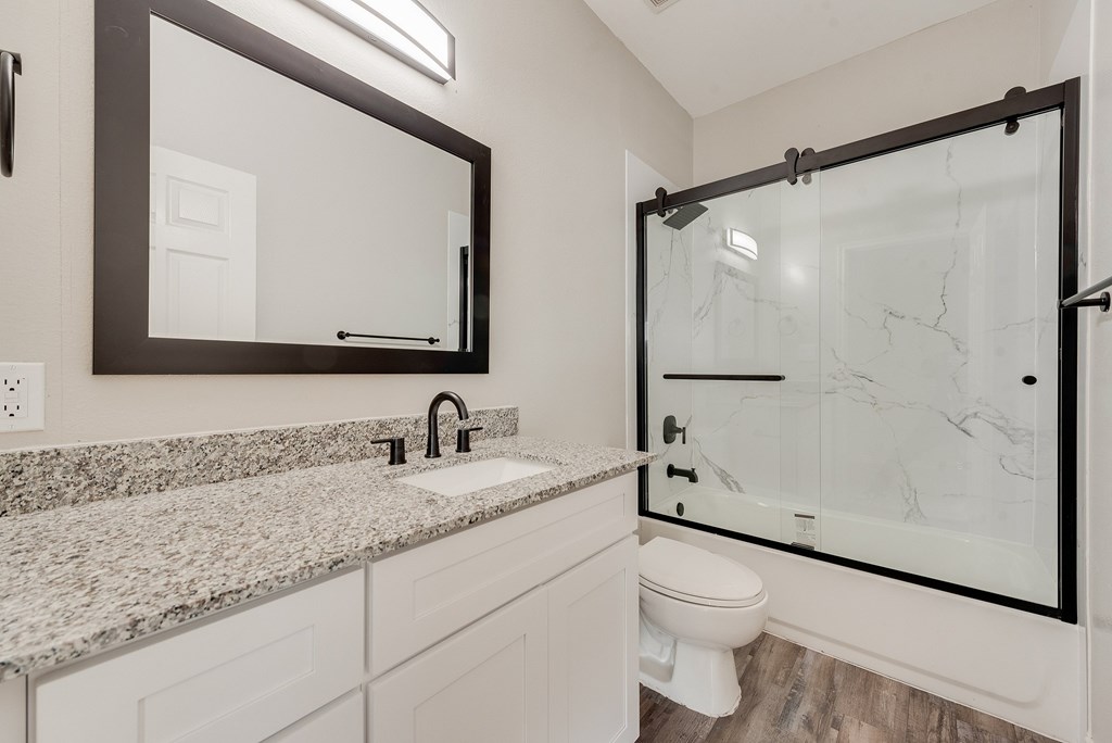 A red brick building with a garage underneath.