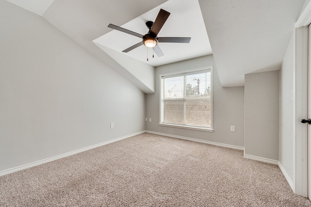A parking garage with cars parked under a building.