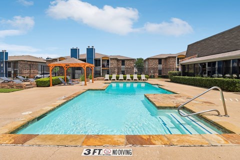 A 3ft diving board is in the middle of a swimming pool.