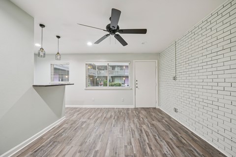 A bedroom with a bed, nightstand, and a ceiling fan.