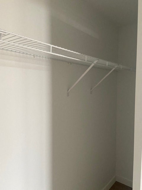 A white shelf is mounted on a white wall.