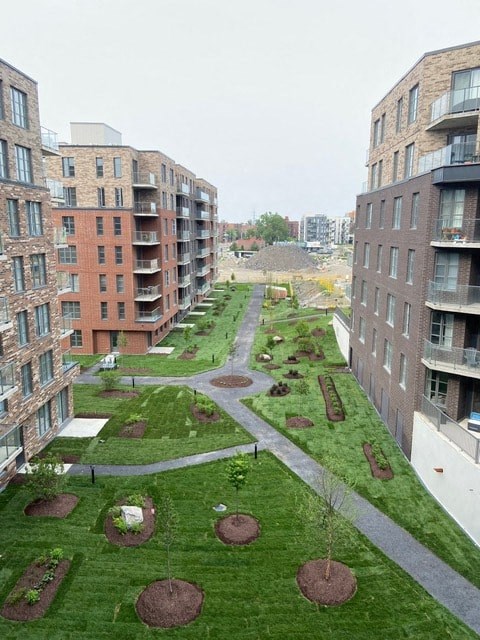 Apartment complex with a green lawn in between.