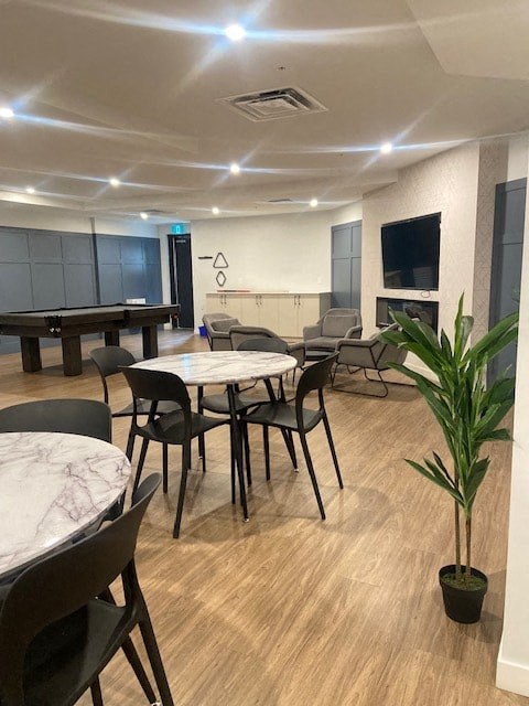 A room with a table and chairs and a plant.