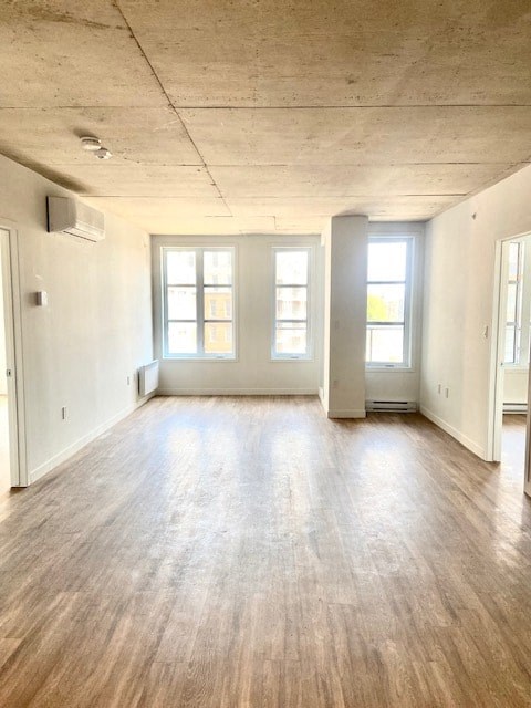 A room with wooden floors and white walls.