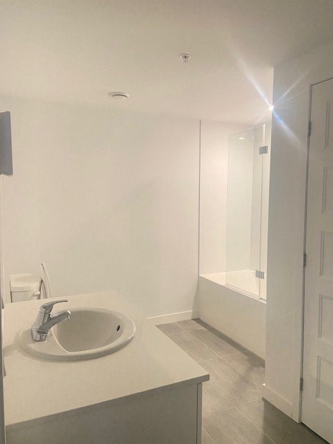 A bathroom with a sink and a mirror.