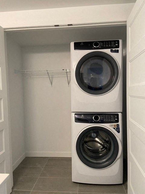 Two white front loading washing machines in a small laundry room.