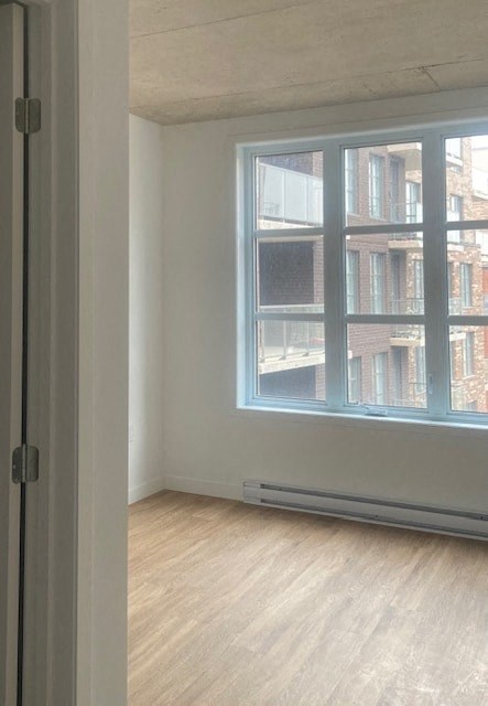 A room with a large window and a wooden floor.