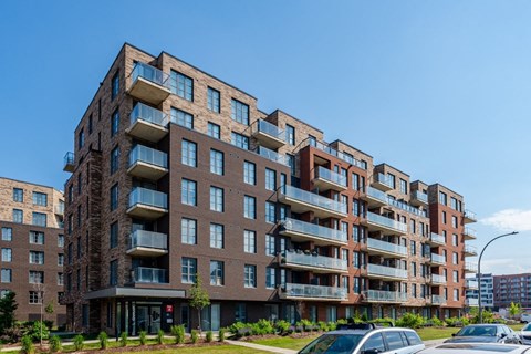 A large apartment building with balconies and multiple stories.