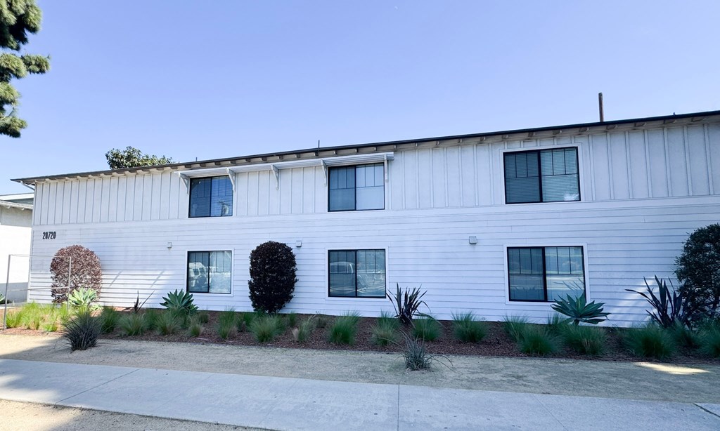 A white building with a blue sky in the background.