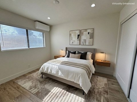 A bedroom with a large bed and two lamps.
