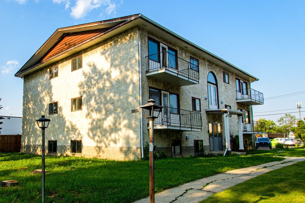 A building with a balcony and a brown roof.
