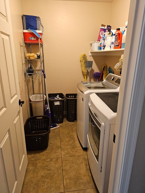 A kitchen with a white oven and a white fridge with a white door.