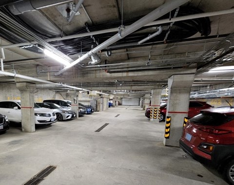 A parking garage with cars parked in it.