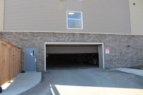 A garage door is open and a sign is on the wall.
