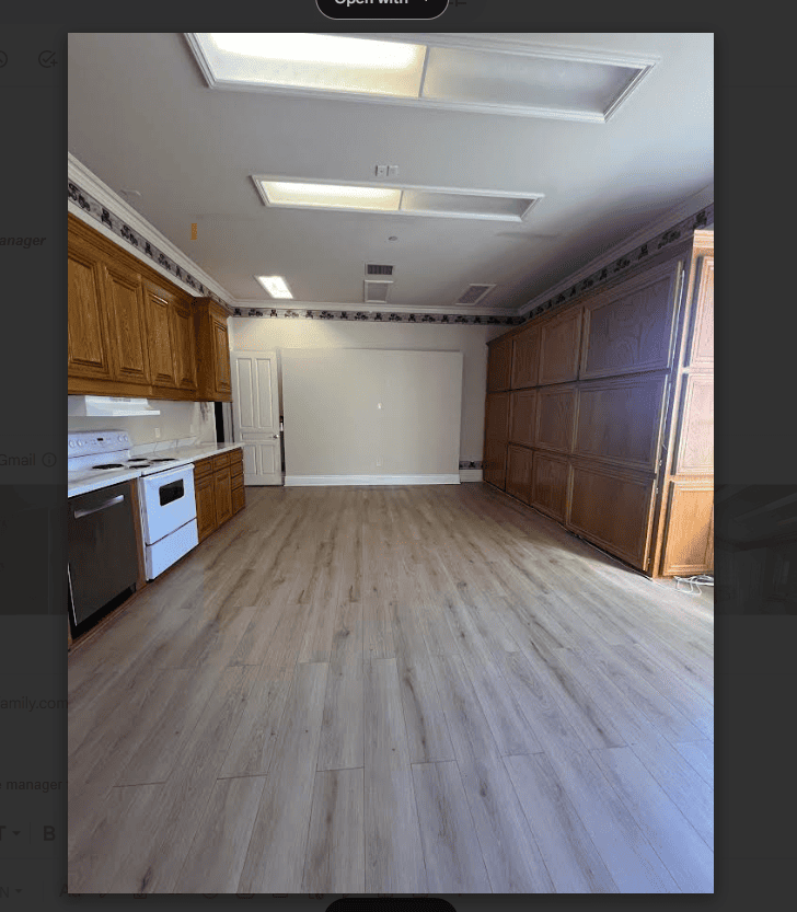 A kitchen with wooden cabinets and a white dishwasher.
