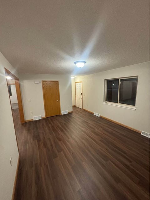 A room with wooden floors and a window.