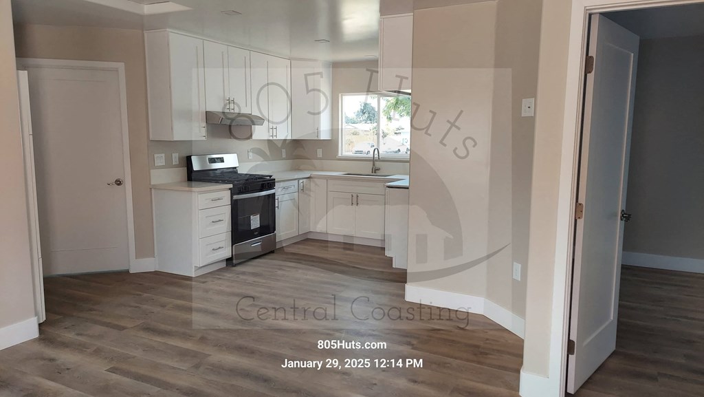 A kitchen with a stove top oven and a microwave.