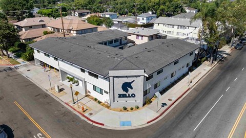 A bird logo is on the front of a white building.