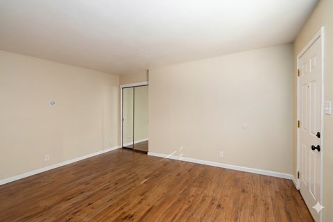 A room with wooden floors and white walls.