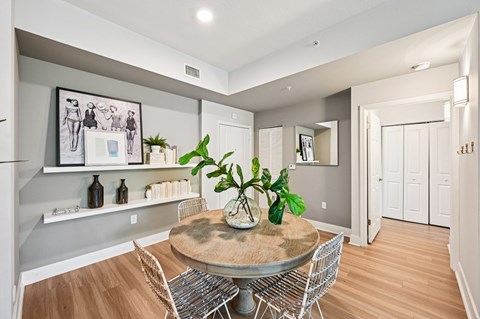 A dining room with a table and chairs.