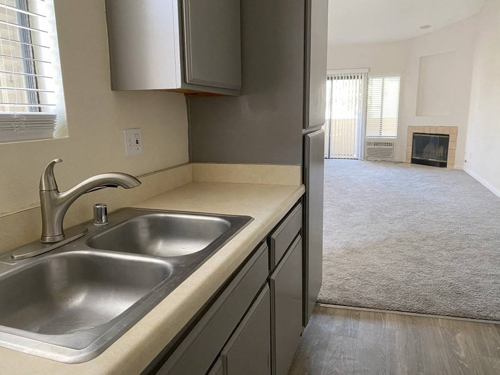 A kitchen with a sink and a window.