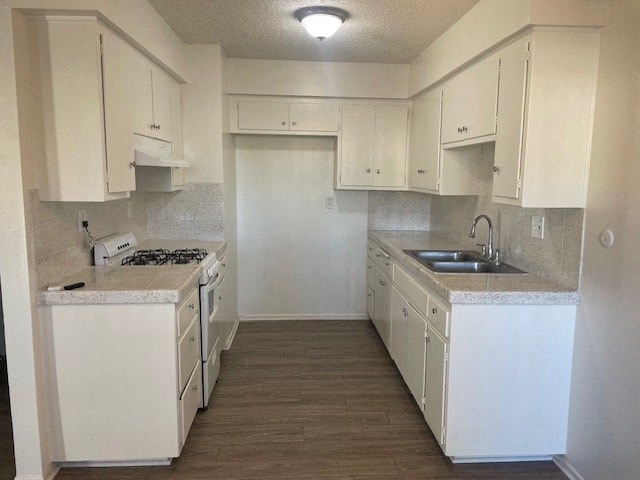 A kitchen with white cabinets and a white counter top.