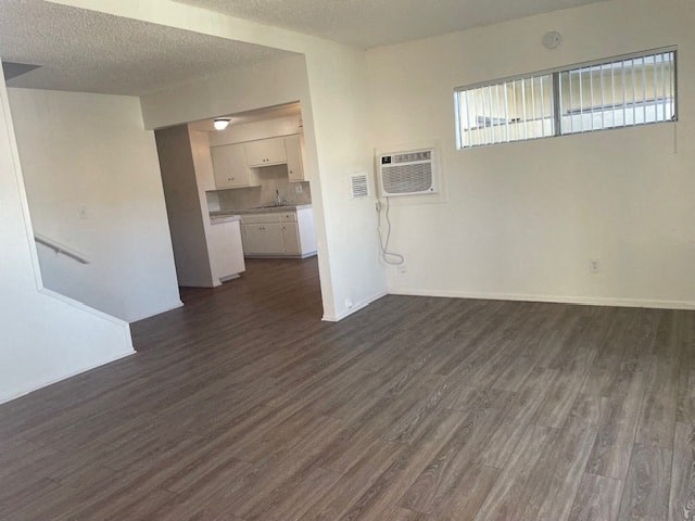 A room with wooden flooring and a window with blinds.
