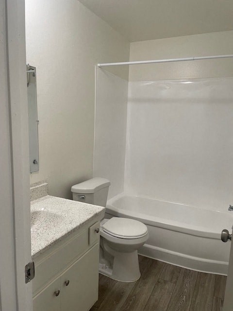 A white bathroom with a toilet, sink, and bathtub.
