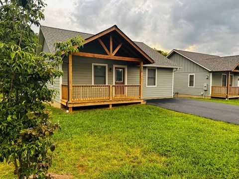 A house with a grey roof and a wooden deck.