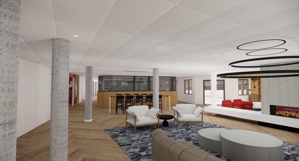 A modern living room with a white sofa, a black coffee table, and a fireplace.