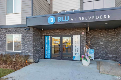 The entrance to a BLU at Belvedere store with a sign that says "Now Renting".