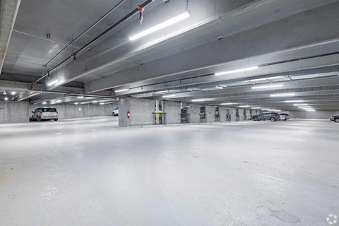 A spacious, empty parking garage with white walls and floors.
