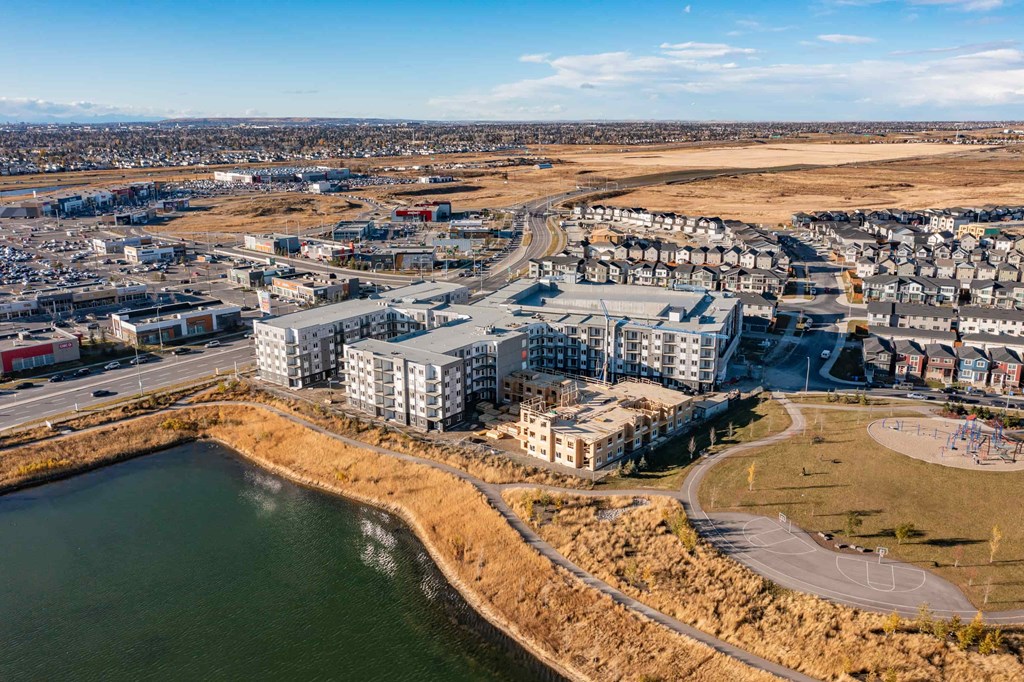 A large body of water is surrounded by apartment buildings.