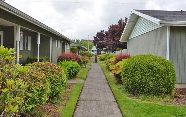 A pathway leads between two rows of houses.