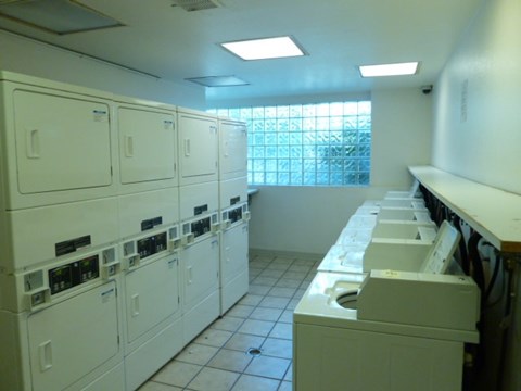 A row of washing machines in a laundromat.