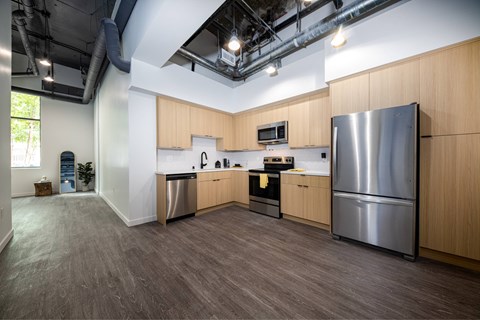 A modern kitchen with wooden cabinets and stainless steel appliances.