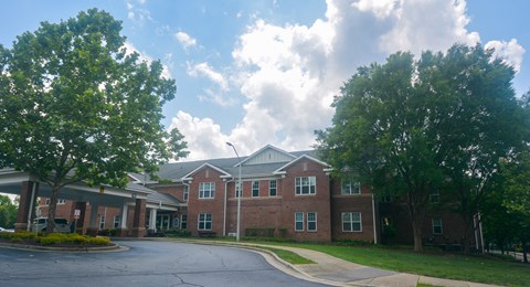 A large building with a parking lot in front.