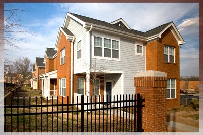 A house with a black fence in front.