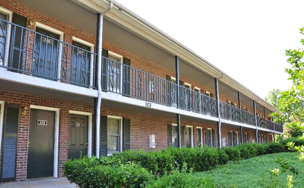 A building with a balcony and doors numbered 102 and 103.