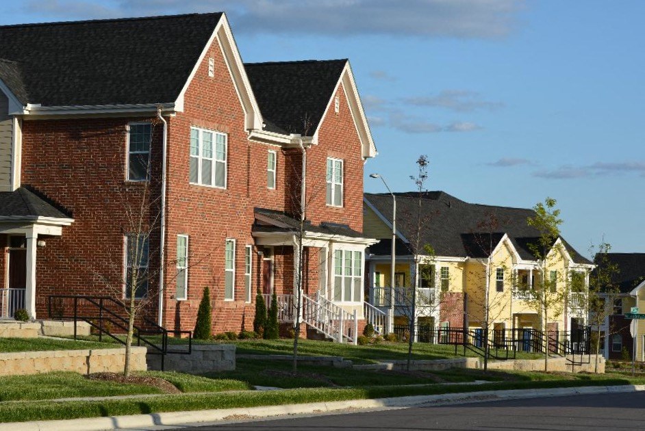 A row of houses with a clear blue sky above them.