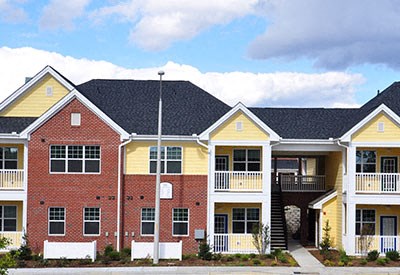 A row of houses with balconies and doors.