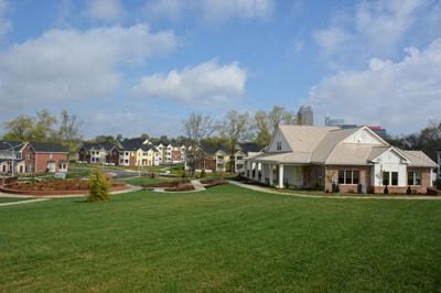 A large grassy area with a building in the background.